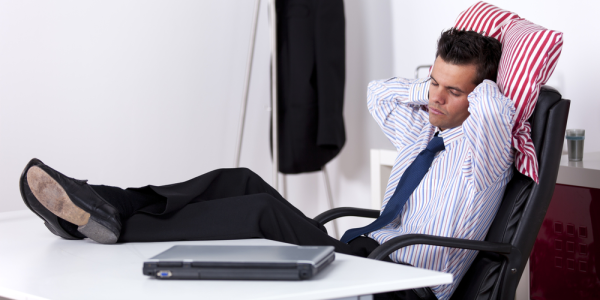 Complacent Sales Leader Relaxing with Feet Up On a Desk