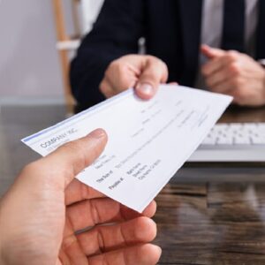 man receiving sales commission plan cheque