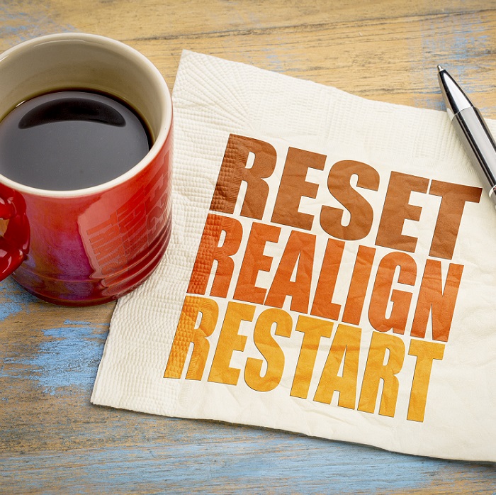 reset, realign, restart concept - word abstract on a napkin with a cup of coffee