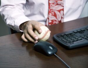Businessman holding a baseball in his hand